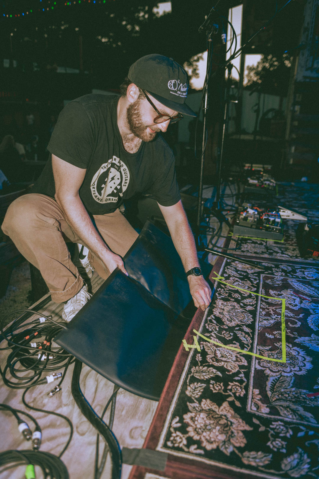 Engineer Ethan Standard hides Molly Tuttles arena pad under the rug